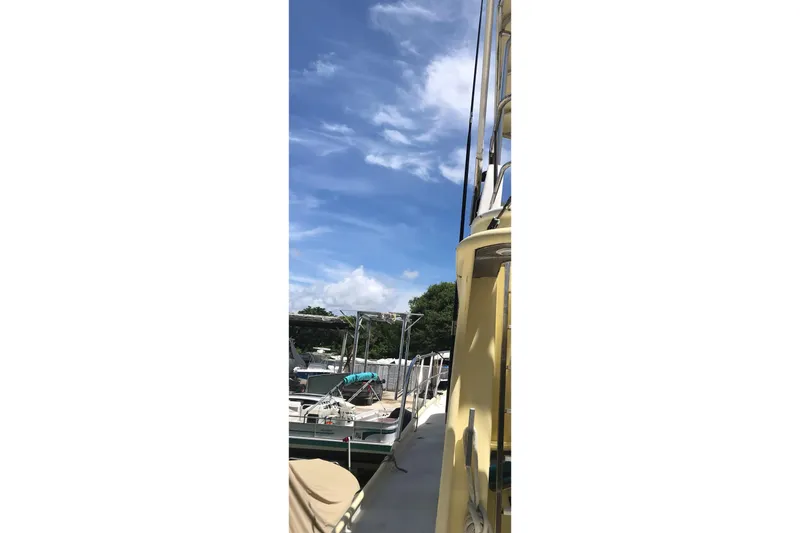 Tuff Baby Yacht Photos Pics Custom 1999 Sport Fishing boat docked under a clear blue sky.