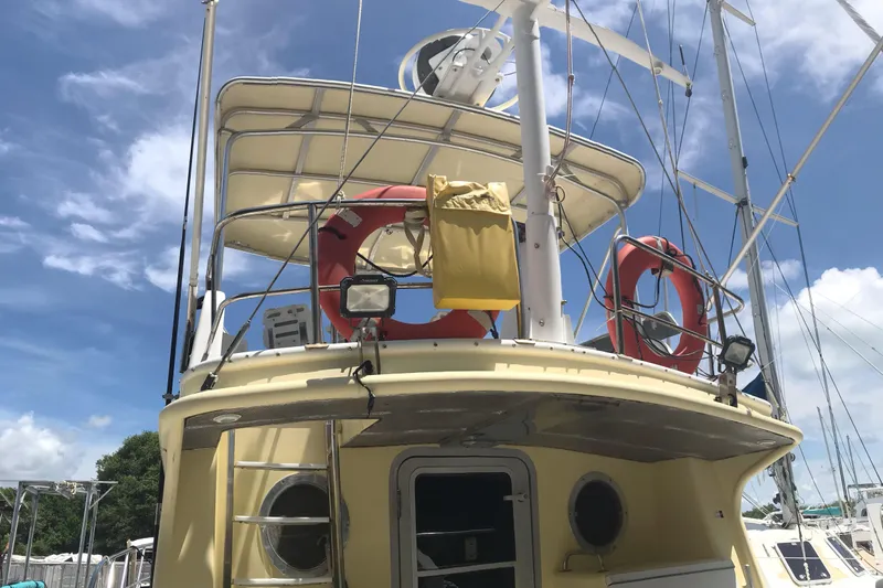 Tuff Baby Yacht Photos Pics 1999 Custom Sport Fishing boat with life rings and equipment under a clear blue sky.