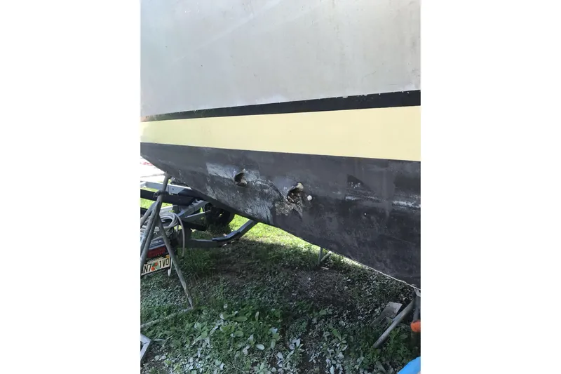 Tuff Baby Yacht Photos Pics Damaged hull of a 1999 Custom Sport Fishing boat on a trailer.
