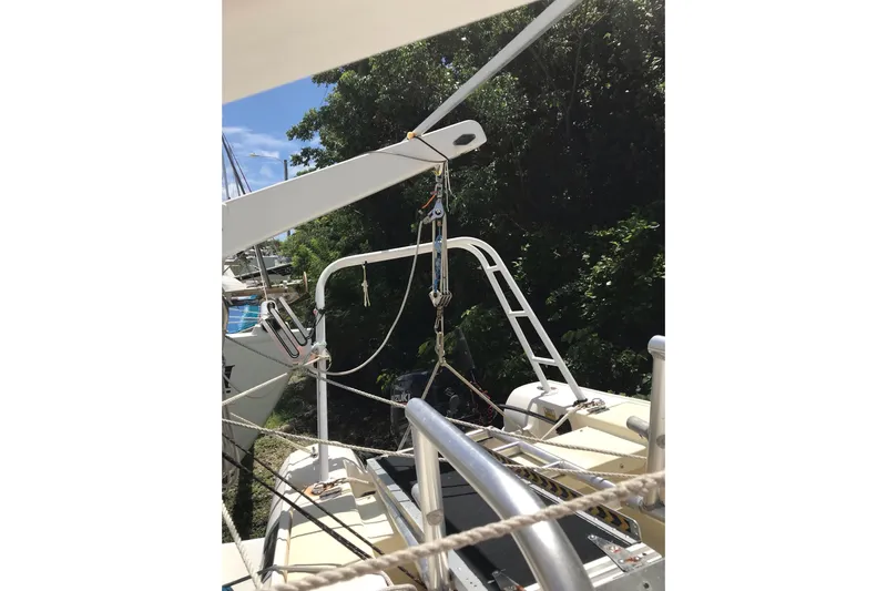 Tuff Baby Yacht Photos Pics Custom 1999 Sport Fishing boat with rigging and equipment, docked near lush greenery.