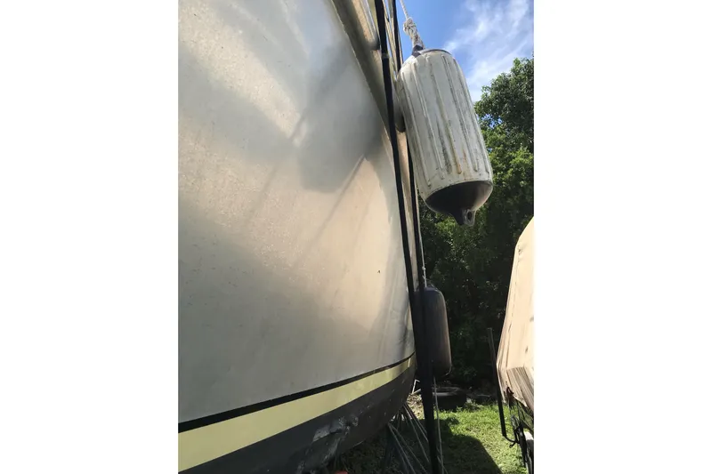 Tuff Baby Yacht Photos Pics 1999 Custom Sport Fishing boat with fenders, docked outdoors.