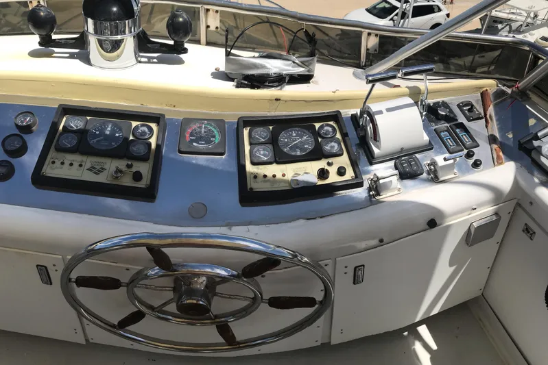 Tuff Baby Yacht Photos Pics Control panel of a 1999 Custom Sport Fishing boat with steering wheel and gauges.
