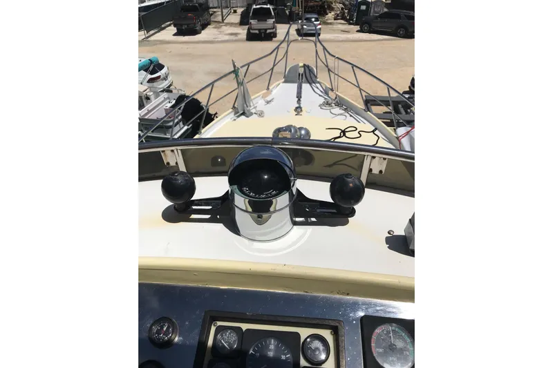 Tuff Baby Yacht Photos Pics 1999 Custom Sport Fishing boat helm with compass and controls, docked in a marina.