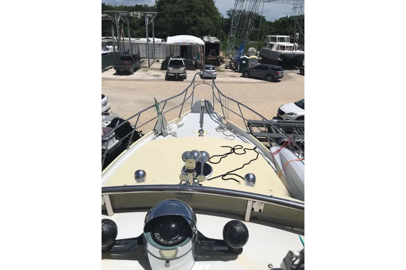 Tuff Baby Yacht Photos Pics 1999 Custom Sport Fishing boat in a marina, surrounded by vehicles and other boats.