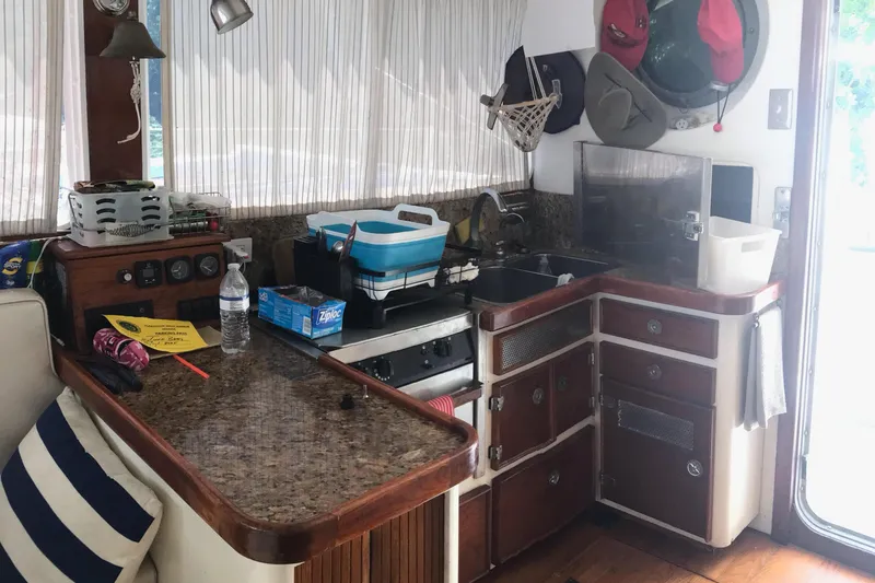 Tuff Baby Yacht Photos Pics Interior of a 1999 Custom Sport Fishing boat with kitchen and storage area.