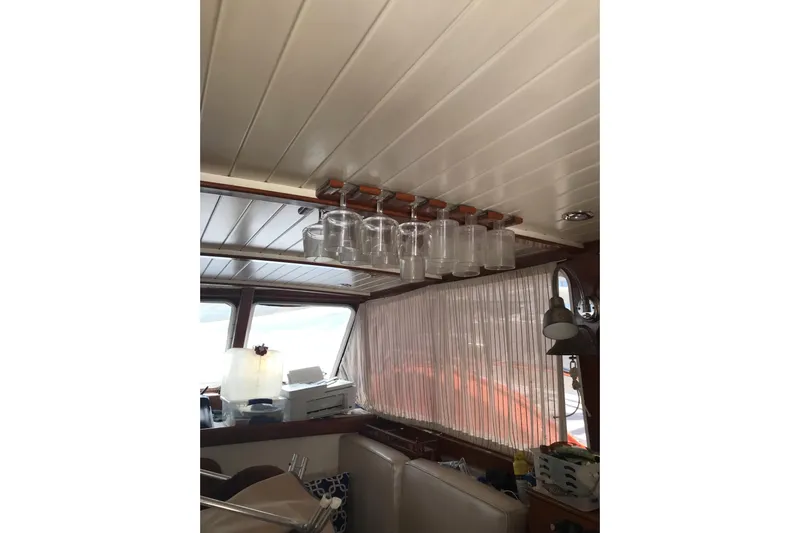 Tuff Baby Yacht Photos Pics Interior of a 1999 Custom Sport Fishing boat with hanging glassware and cozy seating.