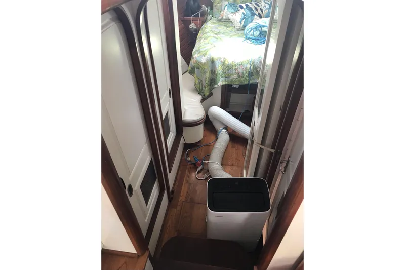 Tuff Baby Yacht Photos Pics Interior of 1999 Custom Sport Fishing boat with air conditioning unit and cozy bed.