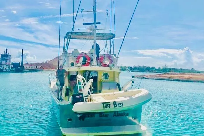 Tuff Baby Yacht Photos Pics Custom 1999 sport fishing boat on clear blue water, docked near shore.