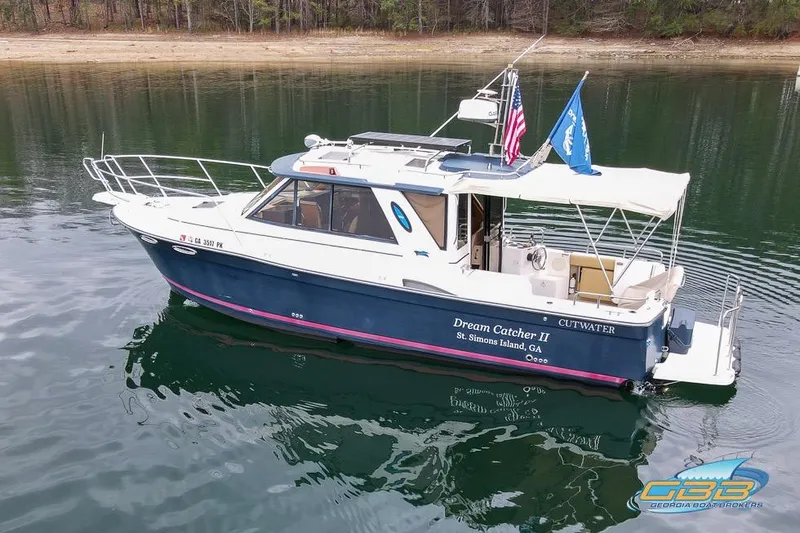  Yacht Photos Pics 2013 Cutwater C-28 boat "Dream Catcher II" on calm water, featuring flags and canopy.