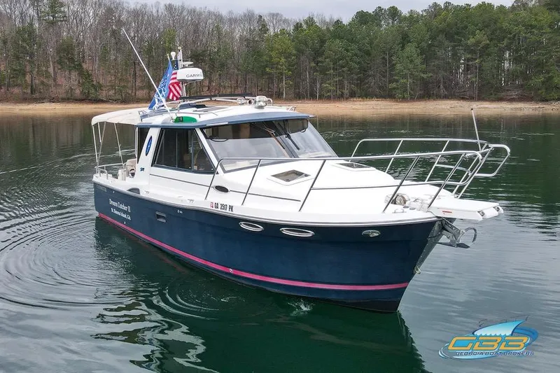  Yacht Photos Pics 2013 Cutwater C-28 boat on calm water, surrounded by trees.