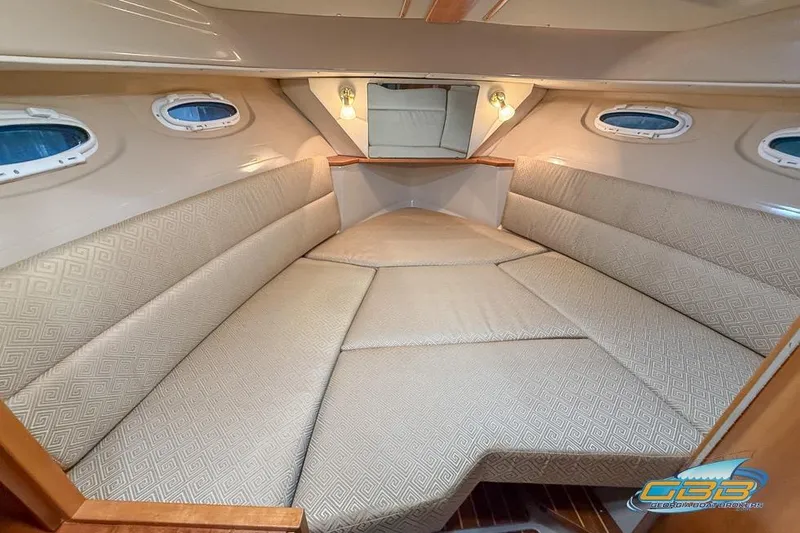  Yacht Photos Pics 2013 Cutwater C-28 cabin interior with beige upholstery and porthole windows.