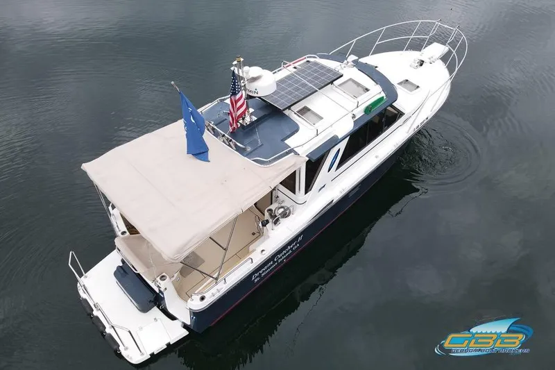  Yacht Photos Pics 2013 Cutwater C-28 boat with solar panels and canopy on calm water.