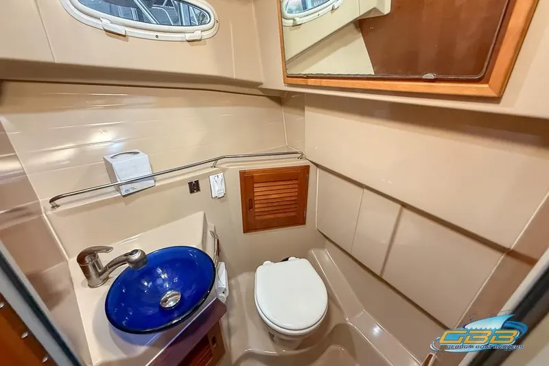  Yacht Photos Pics 2013 Cutwater C-28 boat bathroom with blue sink, toilet, and mirror.