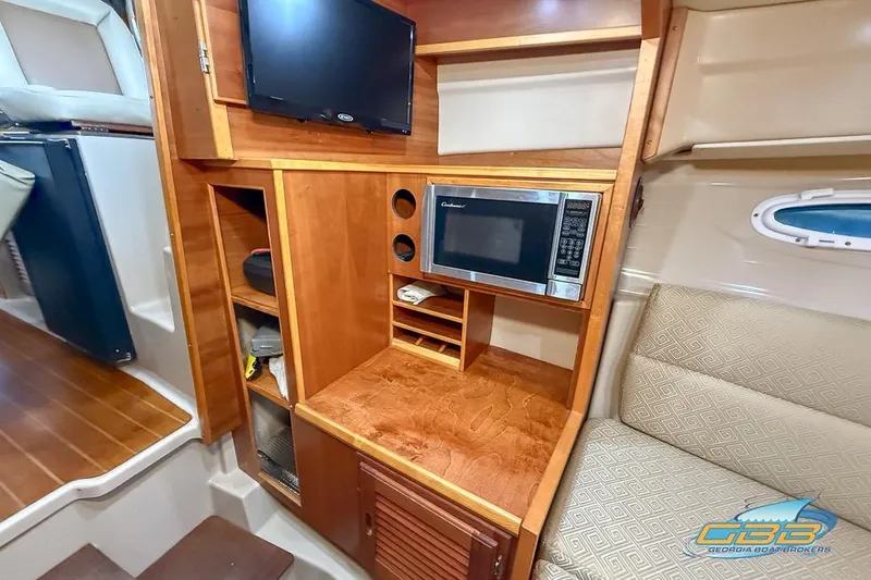  Yacht Photos Pics 2013 Cutwater C-28 interior with microwave, TV, and wooden cabinetry.