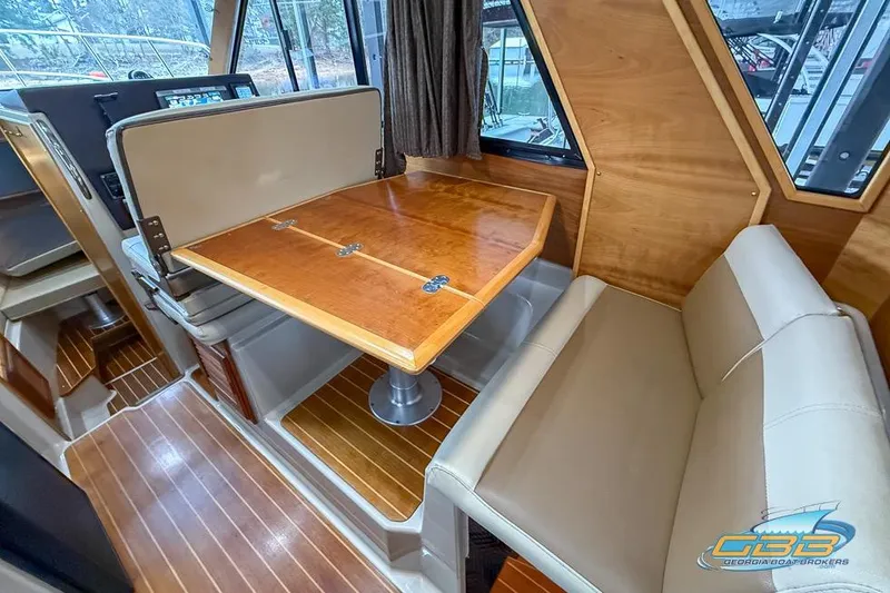  Yacht Photos Pics 2013 Cutwater C-28 interior with wooden table and beige seating.