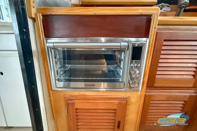  Yacht Photos Pics 2013 Cutwater C-28 interior with a built-in Cosori oven in wooden cabinetry.