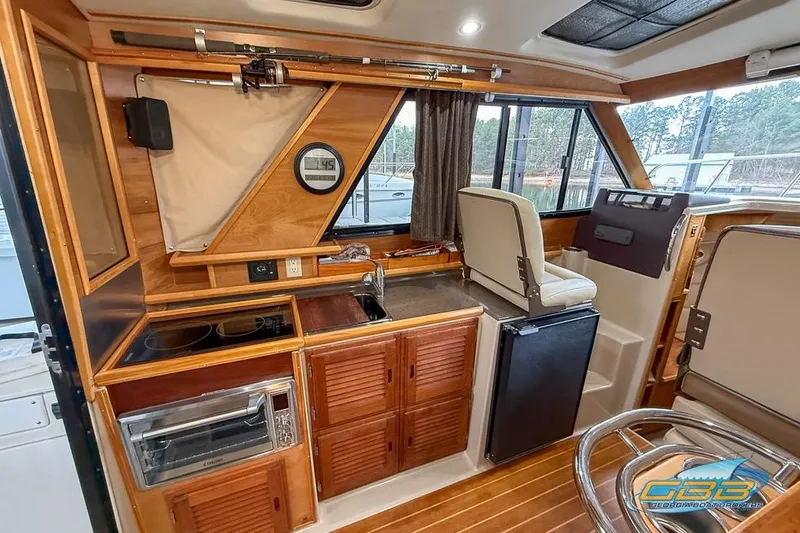  Yacht Photos Pics Interior of a 2013 Cutwater C-28 boat featuring a compact kitchen and seating area.