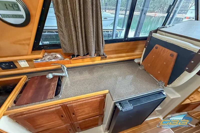  Yacht Photos Pics 2013 Cutwater C-28 boat interior with kitchenette, sink, and compact fridge.