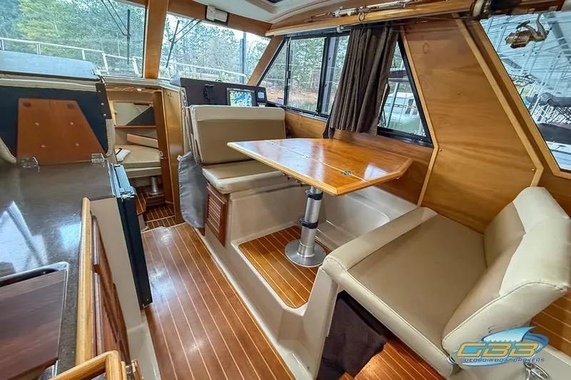  Yacht Photos Pics Interior of 2013 Cutwater C-28 boat with wood accents and seating area.