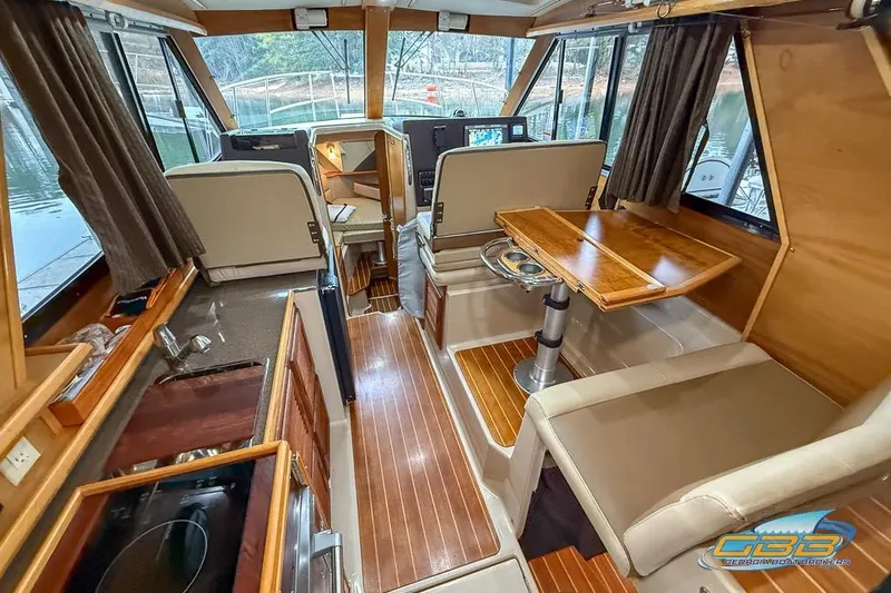  Yacht Photos Pics Interior of 2013 Cutwater C-28 boat with wood accents and seating area.