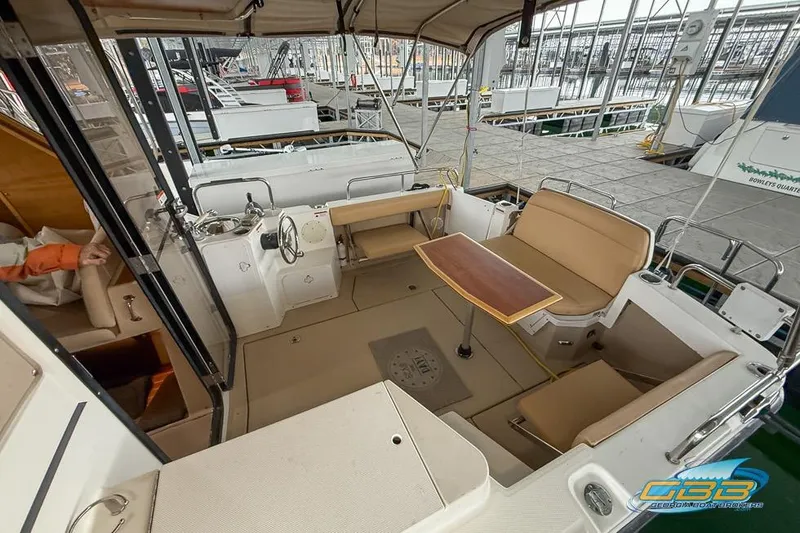  Yacht Photos Pics 2013 Cutwater C-28 boat interior with seating and table at a marina.