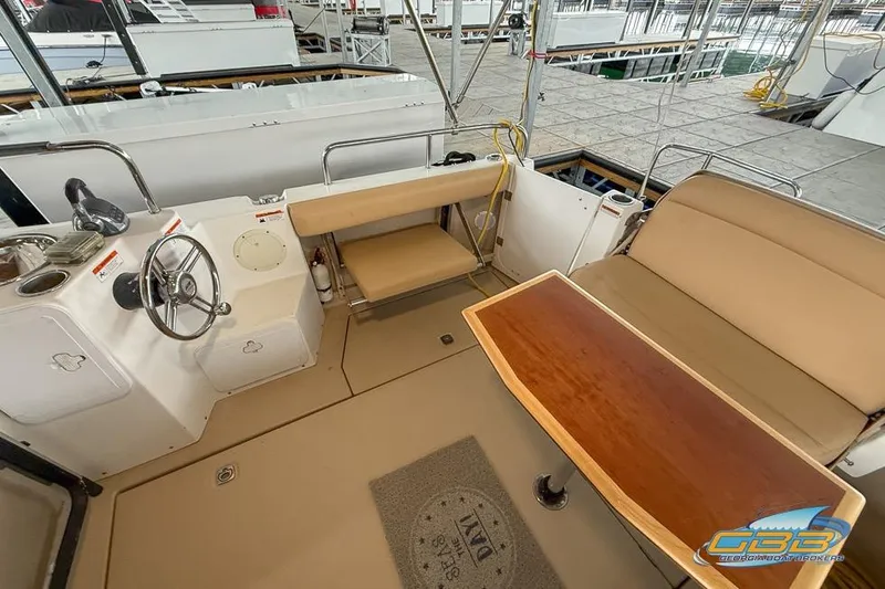  Yacht Photos Pics 2013 Cutwater C-28 boat interior with helm, seating, and wooden table.