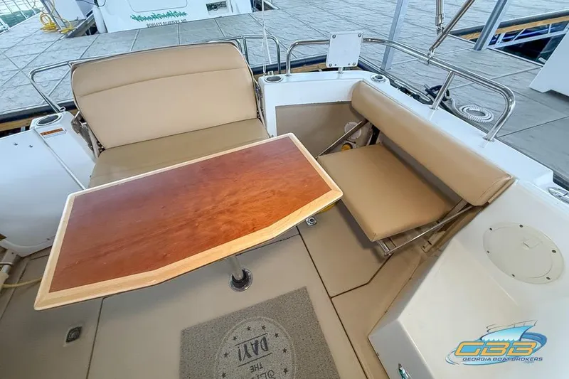 Yacht Photos Pics 2013 Cutwater C-28 boat interior with beige seating and wooden table.