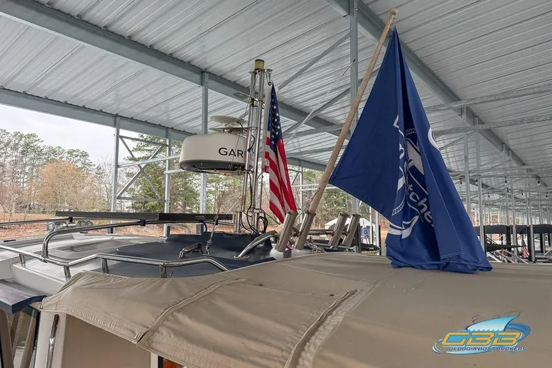  Yacht Photos Pics 2013 Cutwater C-28 boat with flags, docked under a metal canopy.