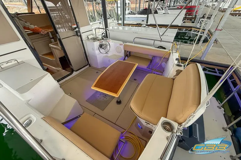  Yacht Photos Pics 2013 Cutwater C-28 boat interior with seating and table, docked at marina.