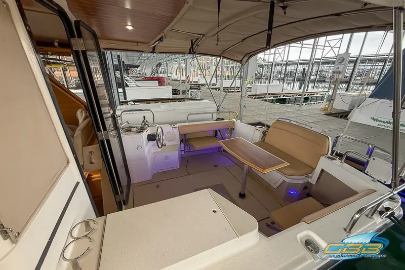  Yacht Photos Pics 2013 Cutwater C-28 boat interior with seating and table, docked at a marina.