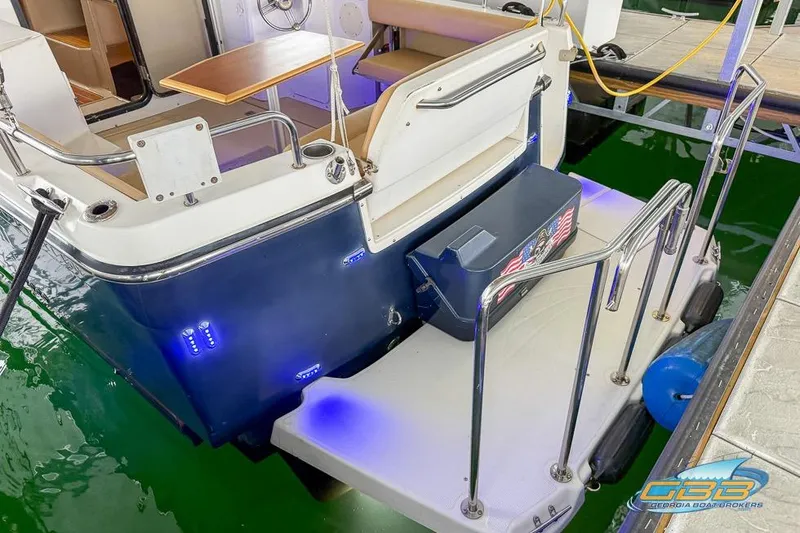  Yacht Photos Pics 2013 Cutwater C-28 boat stern with seating, table, and blue LED lights.