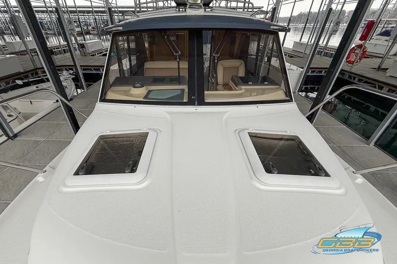  Yacht Photos Pics 2013 Cutwater C-28 boat docked, featuring a spacious deck and cabin windows.