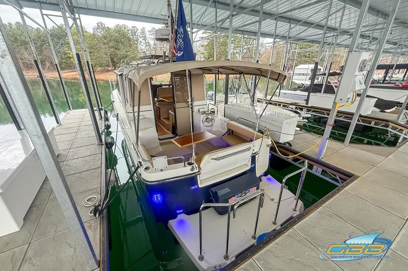  Yacht Photos Pics 2013 Cutwater C-28 boat docked in a covered marina with blue underwater lights.
