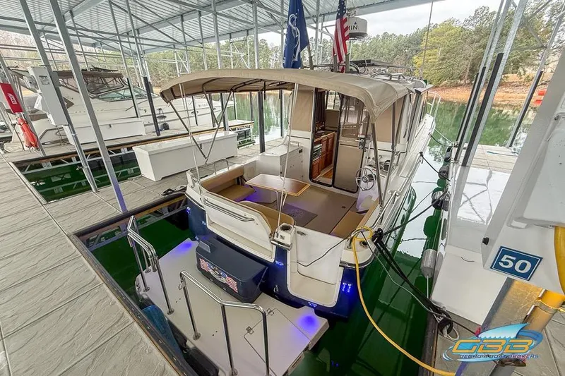  Yacht Photos Pics 2013 Cutwater C-28 boat docked in a marina with canopy and flags.