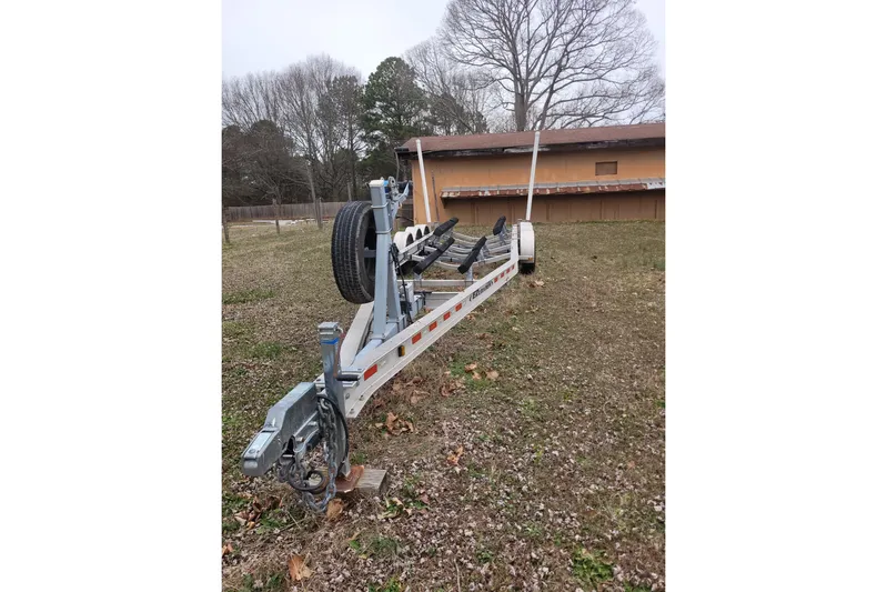  Yacht Photos Pics Trailer for 2013 Cutwater C-28 boat on grassy yard, near a building.