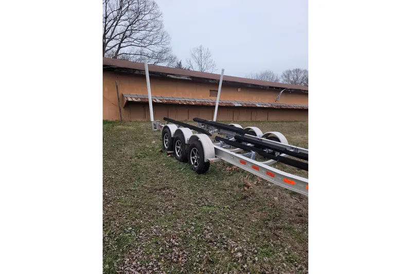 Yacht Photos Pics Trailer for 2013 Cutwater C-28 boat parked on grassy area near building.