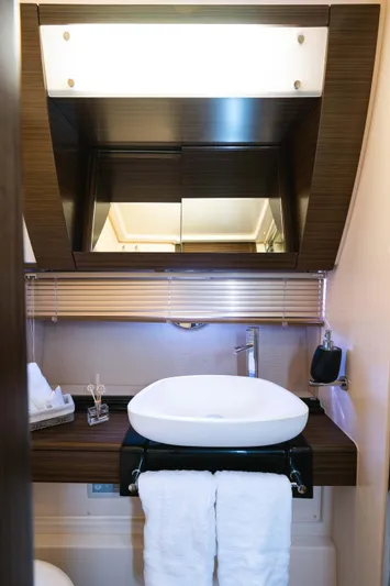 Kenostar Yacht Photos Pics Luxurious bathroom interior of 2015 Azimut 55S yacht with modern sink and elegant wood finish.