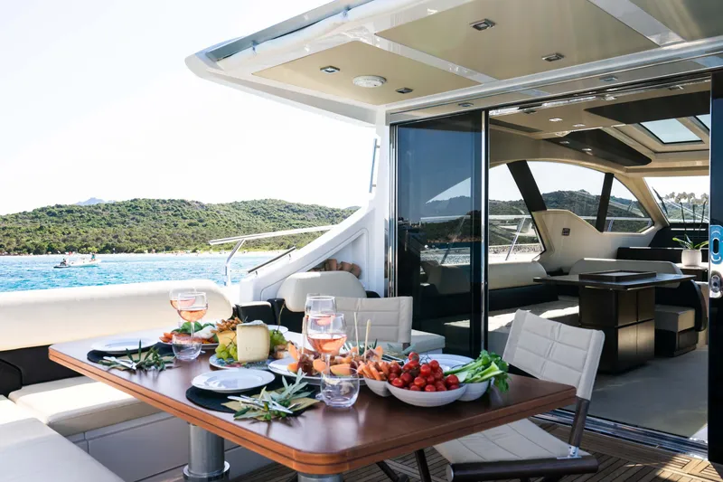 Kenostar Yacht Photos Pics Luxurious 2015 Azimut 55S yacht with elegant dining setup and scenic ocean view.