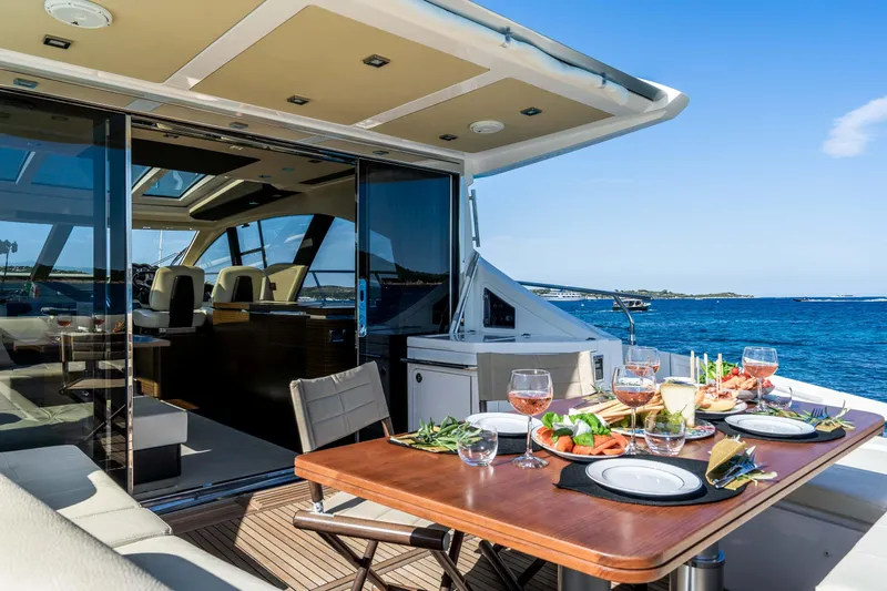 Kenostar Yacht Photos Pics Luxurious 2015 Azimut 55S yacht with elegant outdoor dining setup by the sea.