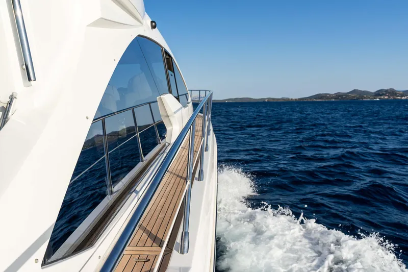 Kenostar Yacht Photos Pics Azimut 55S yacht cruising on open sea, 2015 model, side view with clear blue sky.