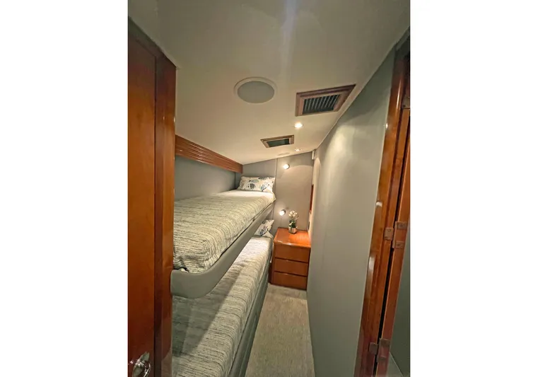 Empress Yacht Photos Pics Interior of 2000 Hatteras 60 Convertible yacht with bunk beds and wooden cabinetry.