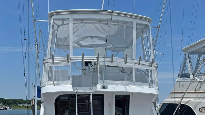 Empress Yacht Photos Pics 2000 Hatteras 60 Convertible yacht with enclosed flybridge, docked under clear blue sky.