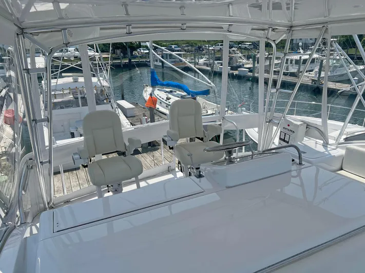 Empress Yacht Photos Pics Hatteras 60 Convertible 2000 yacht interior with helm chairs and marina view.