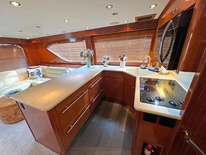 Empress Yacht Photos Pics Luxurious kitchen interior of 2000 Hatteras 60 Convertible yacht with modern amenities.