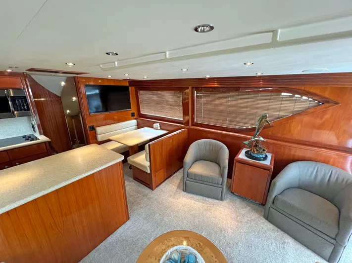 Empress Yacht Photos Pics Luxurious interior of 2000 Hatteras 60 Convertible yacht with elegant wood finishes and modern amenities.