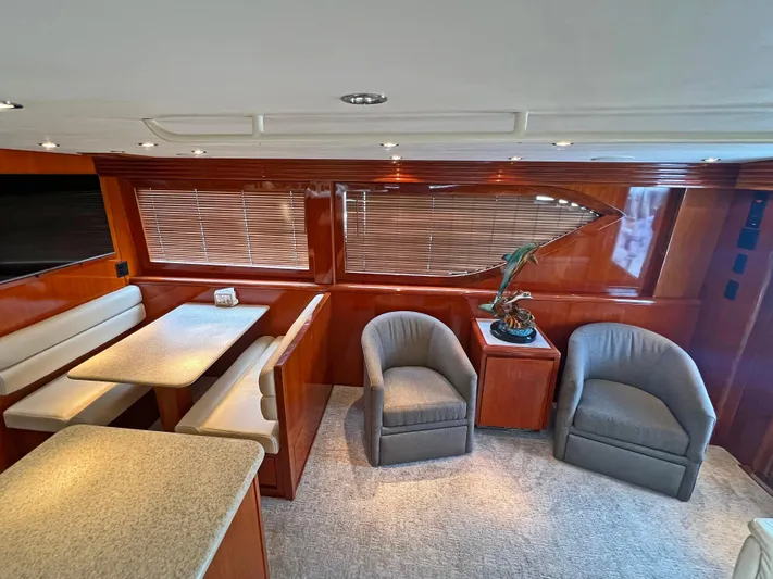 Empress Yacht Photos Pics Luxurious interior of 2000 Hatteras 60 Convertible yacht with seating and dining area.