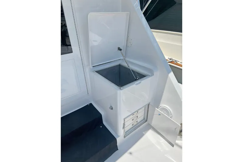 Empress Yacht Photos Pics Hatteras 60 Convertible 2000 yacht interior with open storage compartment and drawers.