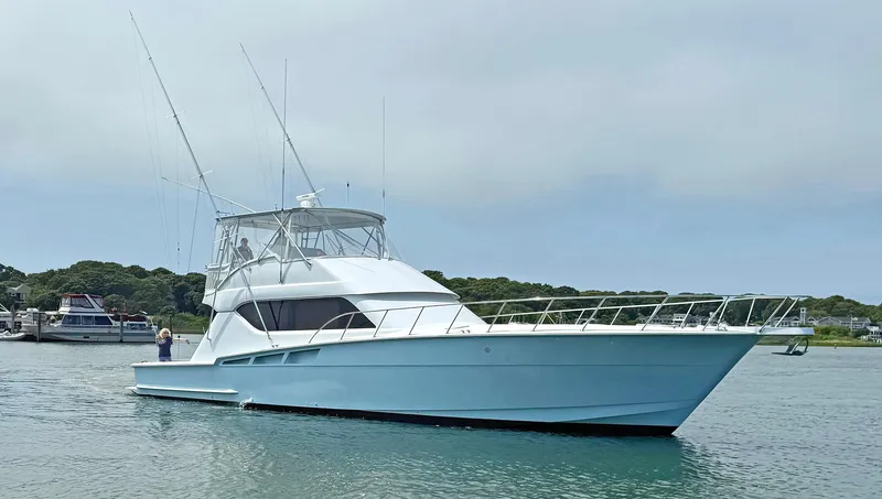 Empress Yacht Photos Pics 2000 Hatteras 60 Convertible yacht on calm water, with clear sky and distant shoreline.