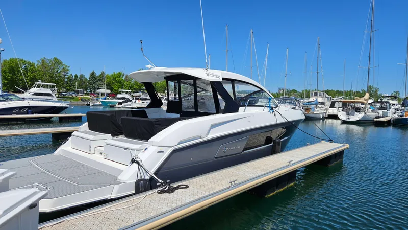  Yacht Photos Pics 2017 Cruisers Yachts 390 Express Coupe docked in a marina under clear blue skies.