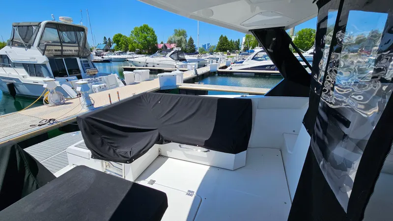 Yacht Photos Pics 2017 Cruisers Yachts 390 Express Coupe at marina, featuring covered seating area.